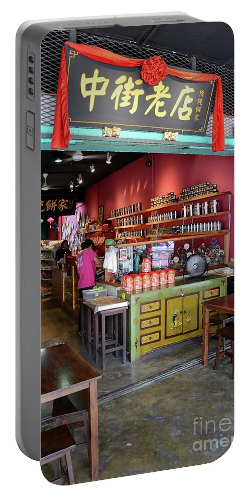 Shop Portable Battery Charger featuring the photograph Customers browse Chinese food shop Jalan Padungan Kuching Sarawak Malaysia by Imran Ahmed