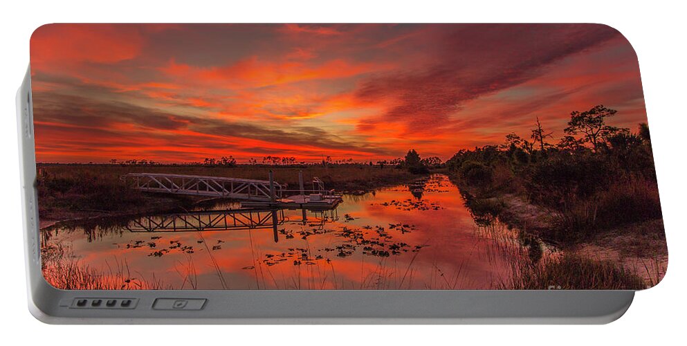 Sun Portable Battery Charger featuring the photograph Explosive Sunset at Pine Glades by Tom Claud
