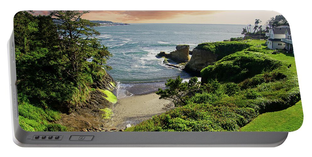 Bay Portable Battery Charger featuring the photograph Tall conifer above protected small cov by Steve Estvanik