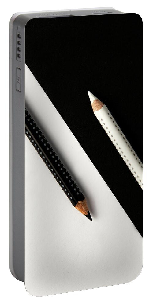 Pencil Portable Battery Charger featuring the photograph Two drawing pencils on a black and white surface. by Michalakis Ppalis