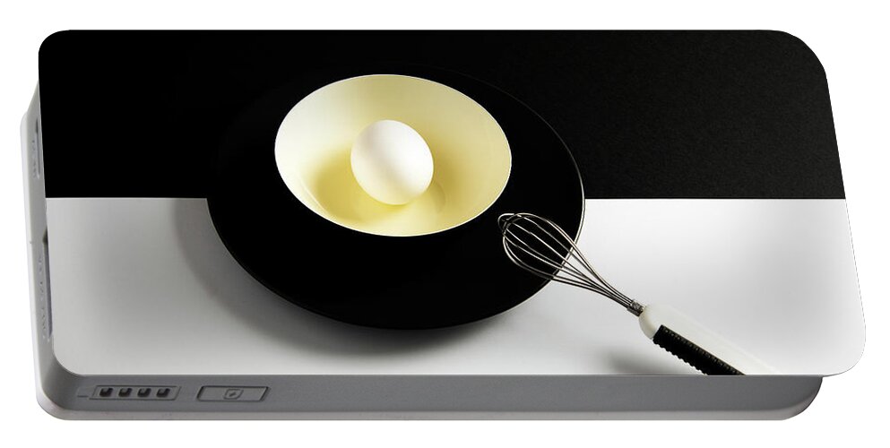 Egg Portable Battery Charger featuring the photograph White egg on a yellow bowl. by Michalakis Ppalis