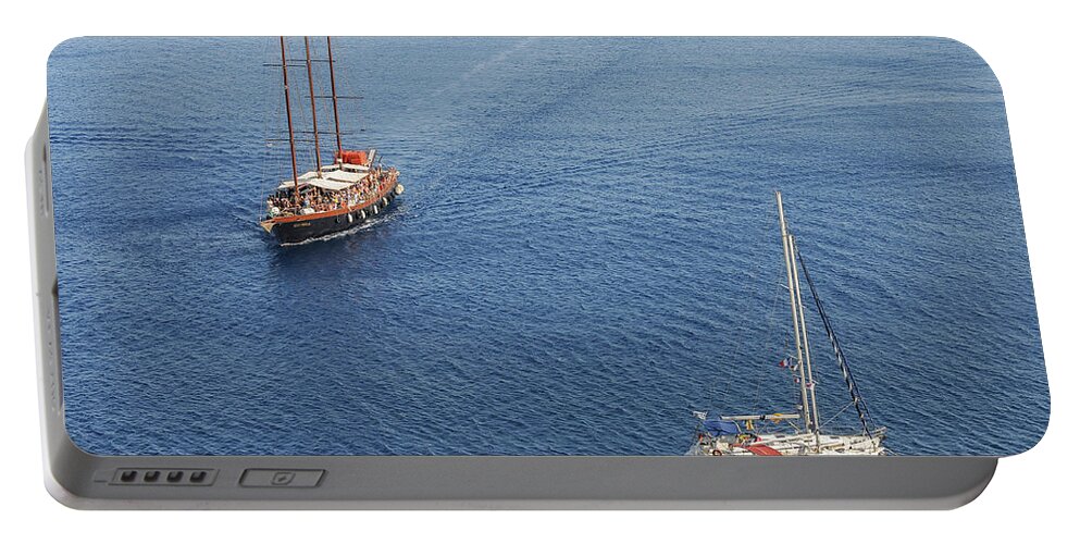Sailing Portable Battery Charger featuring the photograph Yachts sailing on a blue calm sea by Michalakis Ppalis
