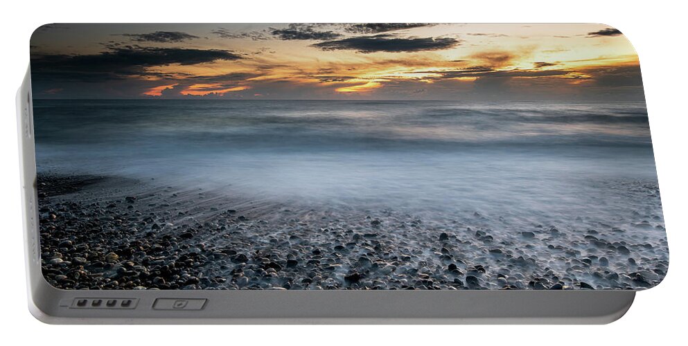Seascape Portable Battery Charger featuring the photograph Seawaves splashing on the coast during a dramatic sunset #2 by Michalakis Ppalis