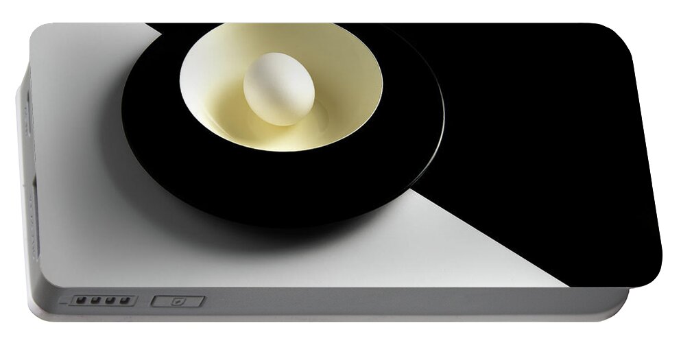 Still-life Portable Battery Charger featuring the photograph Single fresh white egg on a yellow bowl by Michalakis Ppalis