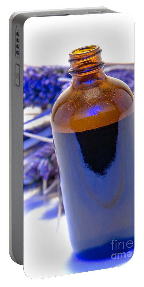 Aromatherapy Portable Battery Charger featuring the photograph Aromatherapy Bottle with Blue Flower Background by Olivier Le Queinec