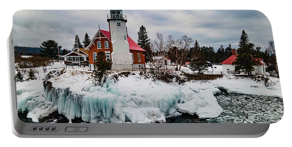Eagle Harbor Mi Portable Battery Charger featuring the photograph Winter view of Eagle Harbor Lighthouse in Eagle Harbor Michigan by Eldon McGraw