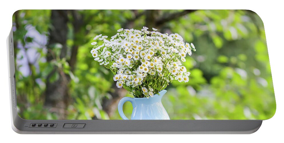 Flower Portable Battery Charger featuring the photograph Bouquet of small white daisy flowers in a blue ceramic vase #3 by Olga Strogonova