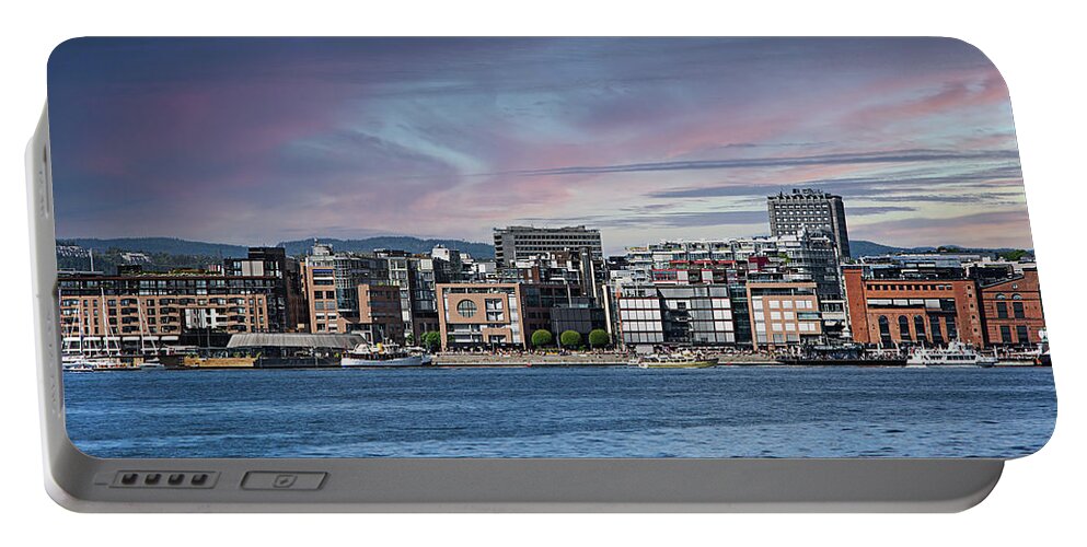 Oslo Portable Battery Charger featuring the photograph Akerbrygge district of Oslo. by Bernhard Schaffer