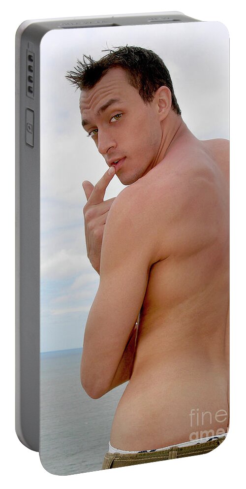 Beach Portable Battery Charger featuring the photograph Attractive, muscular, and silly male model pulls down his pants... by Gunther Allen