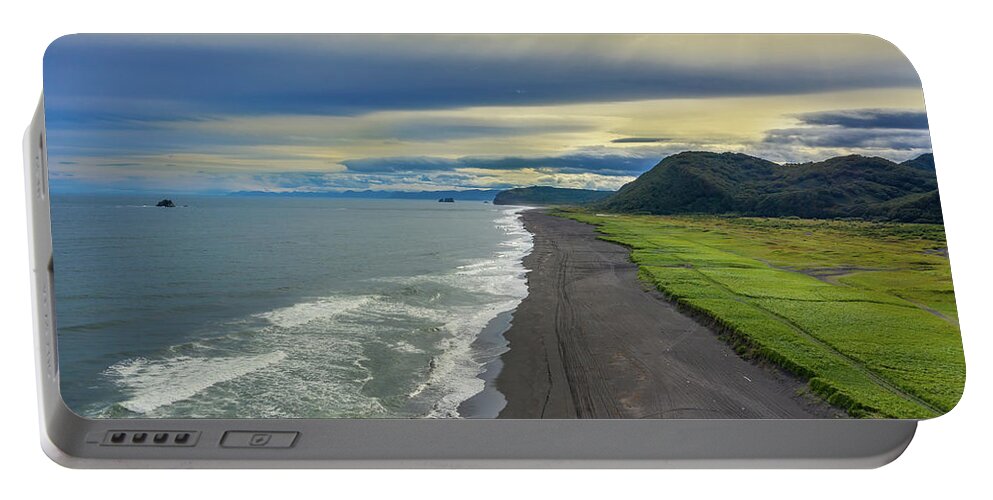 Beach Portable Battery Charger featuring the photograph Beach with black sand on Kamchatka by Mikhail Kokhanchikov