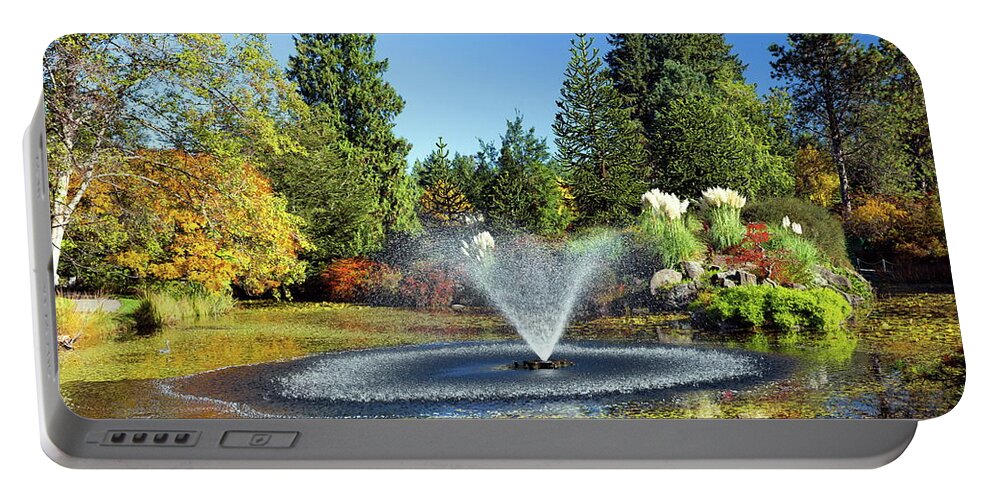 Alex Lyubar Portable Battery Charger featuring the photograph Beautiful pond with fountain by Alex Lyubar