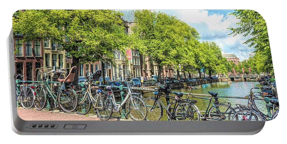 Amsterdam Portable Battery Charger featuring the photograph Bicycles Along the Canals by Debra and Dave Vanderlaan