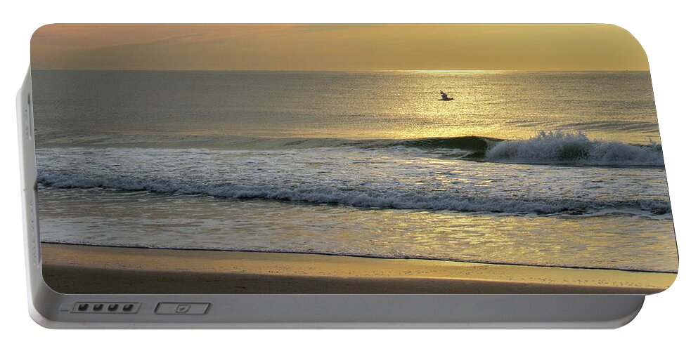 Jersey Shore Portable Battery Charger featuring the photograph Bird in Flight Over Ocean at Sunrise by Matthew DeGrushe