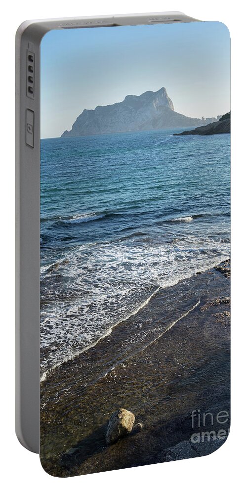 Mediterranean Sea Portable Battery Charger featuring the photograph Blue Mediterranean Sea and the Penon de Ifach in Calpe by Adriana Mueller