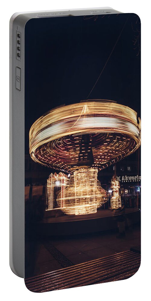 Illuminations Portable Battery Charger featuring the photograph Christmas carousel on the streets of Warsaw. Fire Wheel by Vaclav Sonnek