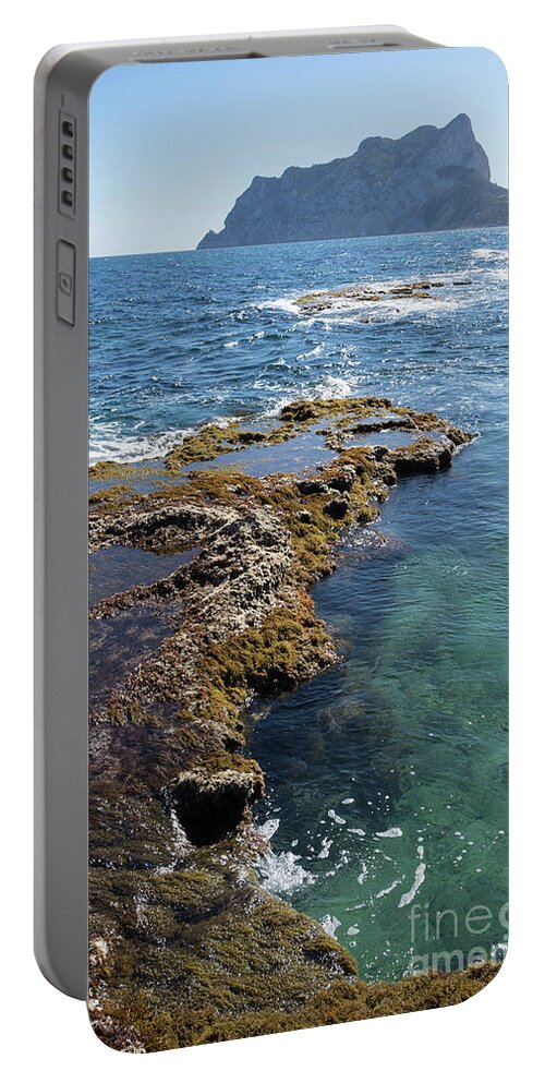 Mediterranean Coast Portable Battery Charger featuring the photograph Clear water and the Penon de Ifach in Calpe by Adriana Mueller