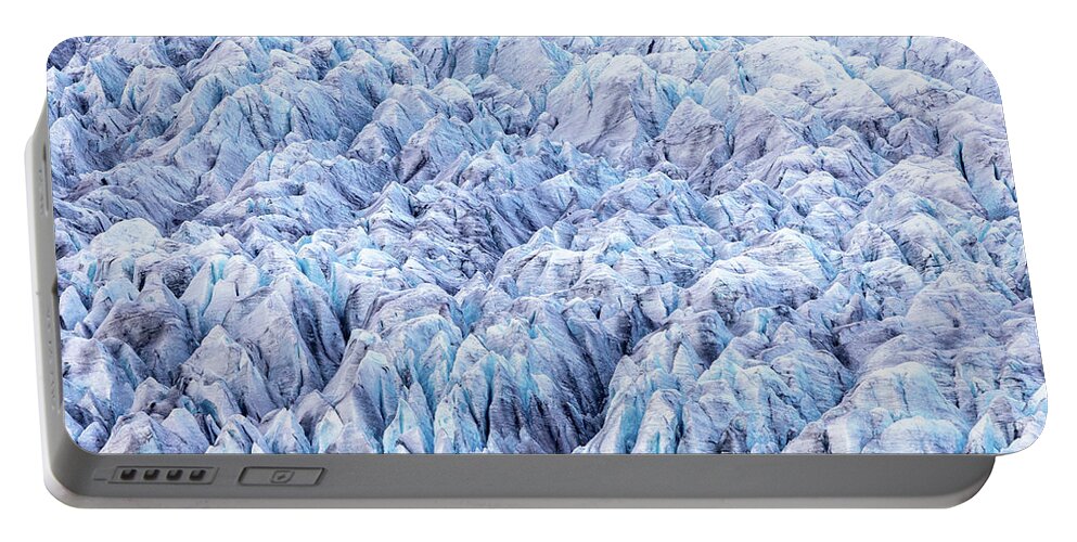 Fjallsarlon Portable Battery Charger featuring the photograph Close up detail of the compressed glacial blue ice of the Fjallsjokull glacier, Southern Iceland. Part of the Vatnajokull National Park by Jane Rix