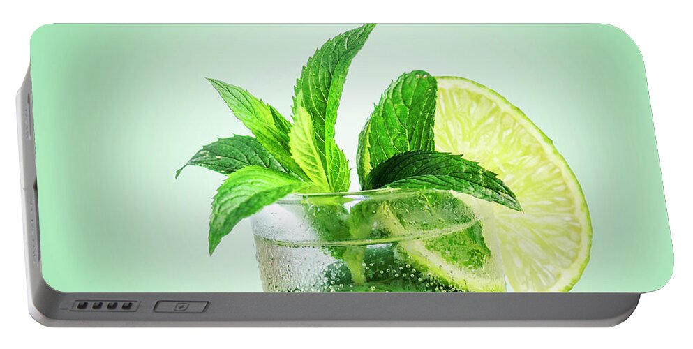 Mojito Portable Battery Charger featuring the photograph Closeup mojito cocktail with ice isolated over pastel background by Jelena Jovanovic