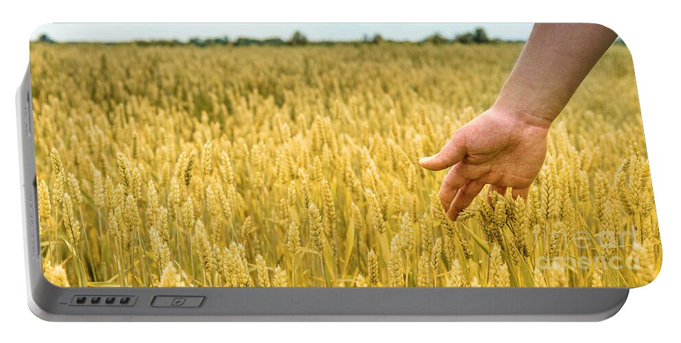 Wheat Portable Battery Charger featuring the photograph Closeup of farmer's hand over wheat by Jelena Jovanovic