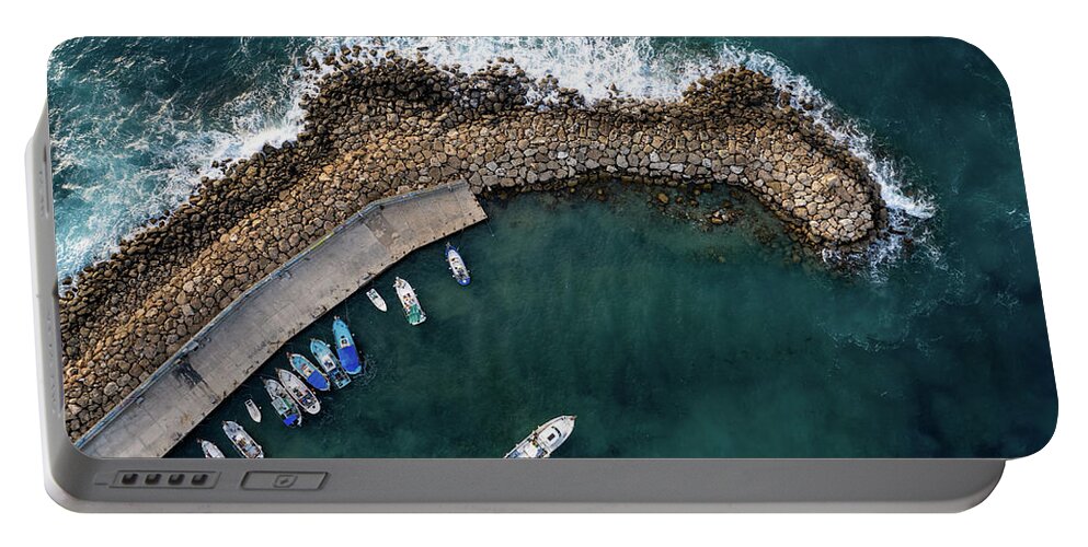 Fishing Harbor Portable Battery Charger featuring the photograph Drone aerial fishing harbour with boats stormy waves, blue sea by Michalakis Ppalis