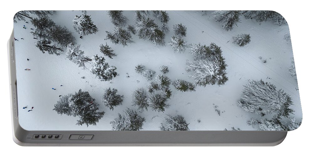 Winter Portable Battery Charger featuring the photograph Drone aerial scenery of mountain snowy forest and people playing in snow. Wintertime season by Michalakis Ppalis