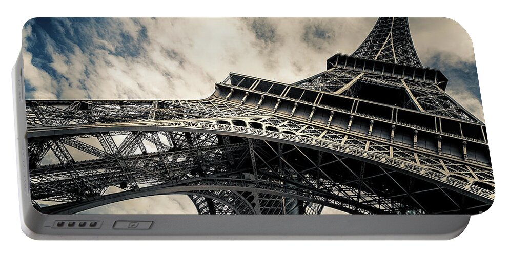 Eiffel Tower Portable Battery Charger featuring the photograph Eiffel Tower with blue sky and cloud background. Low angle view by Jane Rix