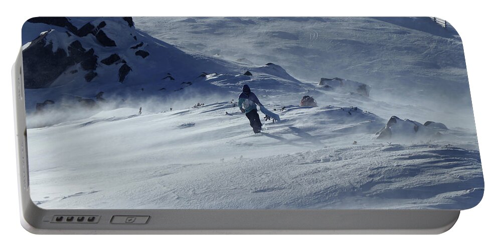 Skier Portable Battery Charger featuring the photograph Extreme winter sport. Young pro snowboarder walks uphill in the halfpipe snow park. Teenager in blue white and black jacket is struggling with the wind. Low Tatras in Slovakia by Vaclav Sonnek