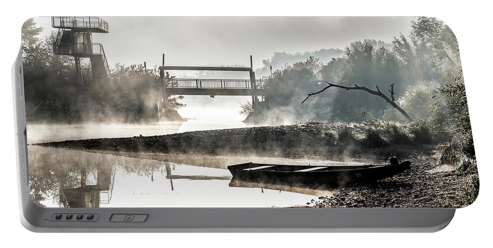 Anchor Portable Battery Charger featuring the photograph Foggy Landscape With Boats On River Bank And Bridge In River Danube National Park In Austria by Andreas Berthold