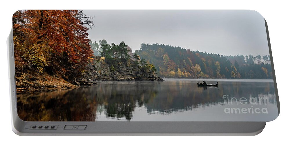 Austria Portable Battery Charger featuring the photograph Foggy Landscape With Fishermans Boat On Calm Lake And Autumnal Forest At Lake Ottenstein In Austria by Andreas Berthold