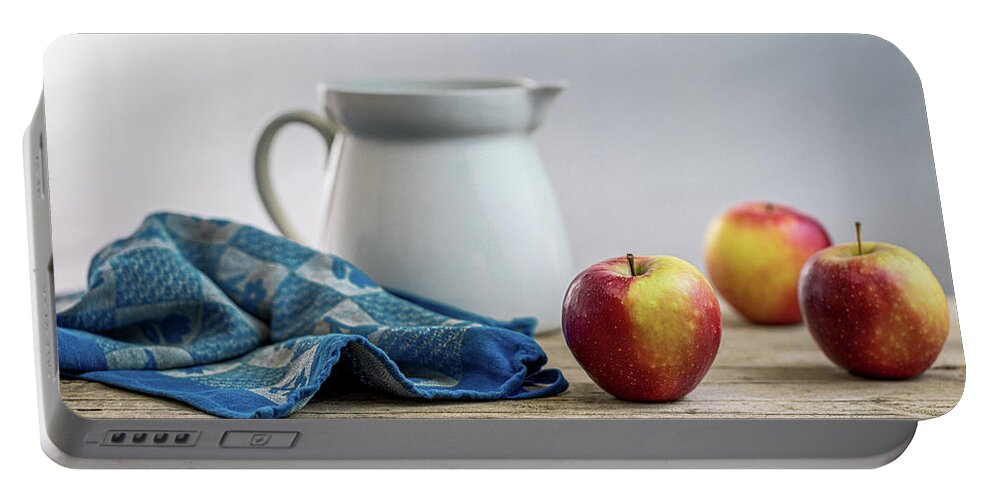 Drinking Glass Portable Battery Charger featuring the photograph Fresh apples on a rustic wooden table by Benoit Bruchez