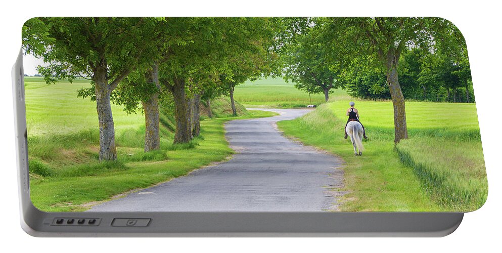 Girl Portable Battery Charger featuring the photograph Girl riding horse in a country road by Fabiano Di Paolo