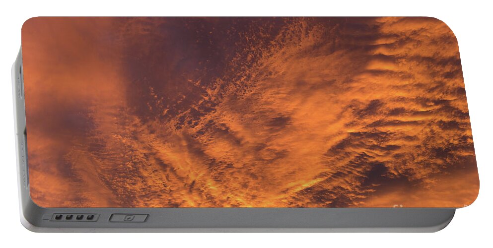 Clouds Portable Battery Charger featuring the photograph Glowing sunset sky with deep orange clouds by Adriana Mueller