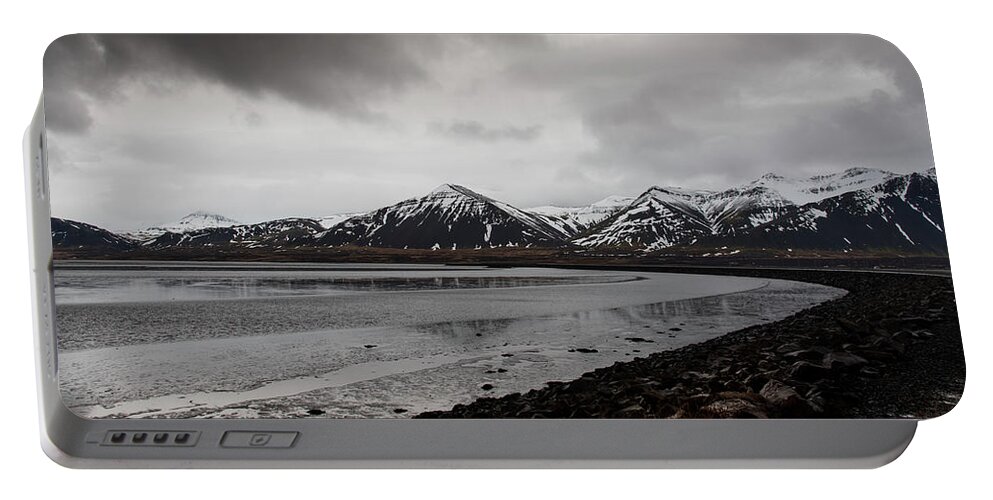 Iceland Portable Battery Charger featuring the photograph Icelandic landscape with frozen lake and mountains covered in snow by Michalakis Ppalis