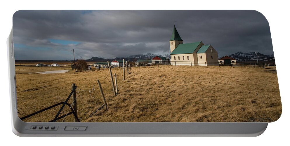 Icelandic Portable Battery Charger featuring the photograph Icelandinc landscape with traditional church in Iceland by Michalakis Ppalis