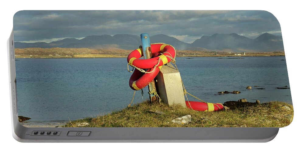 Lifebuoy Connemara Ballyconneely Galway Ireland Saftey Outdoors Ocean Mountains Beach Walking Photography Portable Battery Charger featuring the photograph Life savers by Peter Skelton