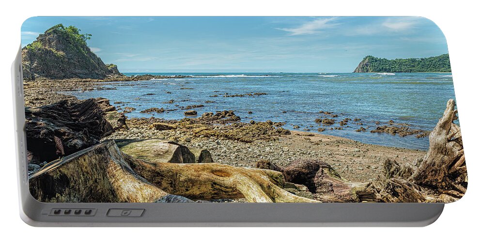 Central America Portable Battery Charger featuring the photograph Logs and stumps washed up on Bella Vista beach - Samara by Henri Leduc