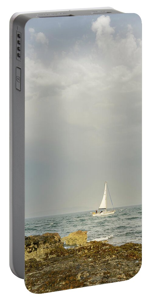 England Portable Battery Charger featuring the photograph Lone Sailor at Penmon Point by Spikey Mouse Photography