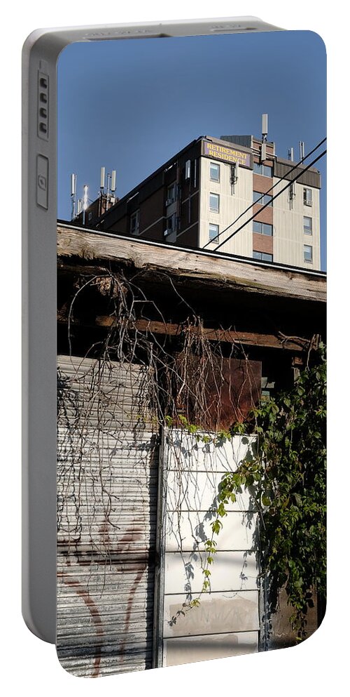 Urban Portable Battery Charger featuring the photograph Looming Retirement by Kreddible Trout