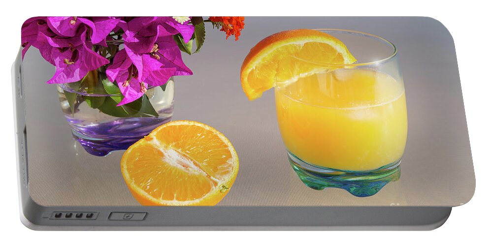 Orange Portable Battery Charger featuring the photograph Orange and tangerine fruit juice in the sunshine by Adriana Mueller