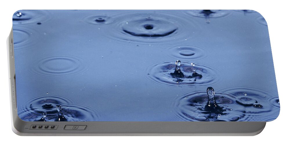 Rain Portable Battery Charger featuring the photograph Rain Drops on Water by Warren Photographic