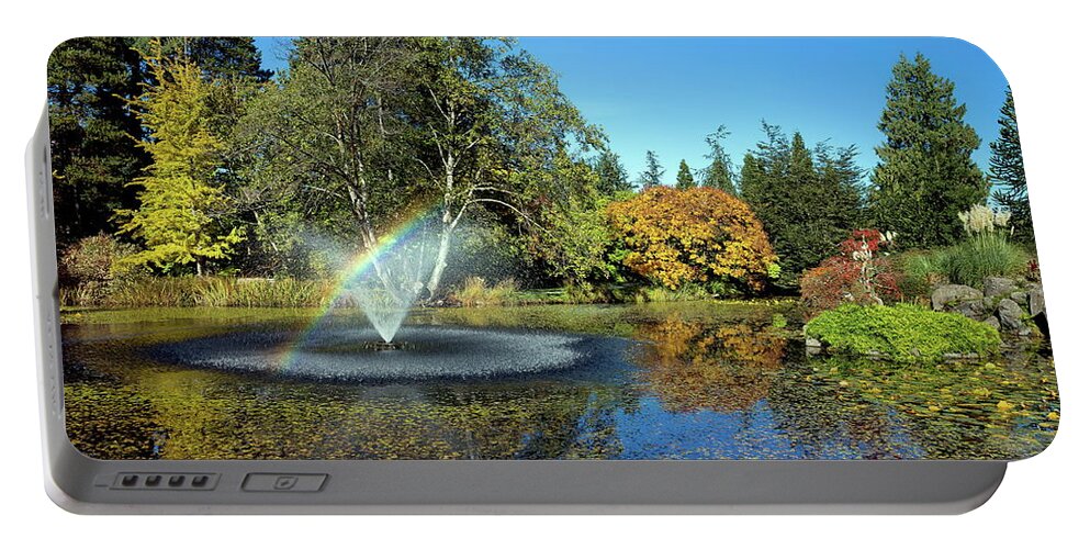 Alex Lyubar Portable Battery Charger featuring the photograph Rainbow in the fountain by Alex Lyubar