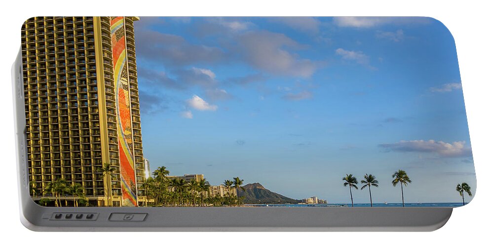 Waikiki Portable Battery Charger featuring the photograph Rainbow tower frames the shore in Waikiki Hawaii by Steven Heap