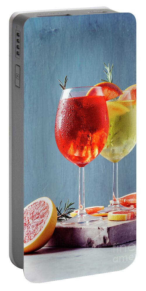 Aperol Portable Battery Charger featuring the photograph Red and white aperol spritz garnish in wine glasses by Jelena Jovanovic