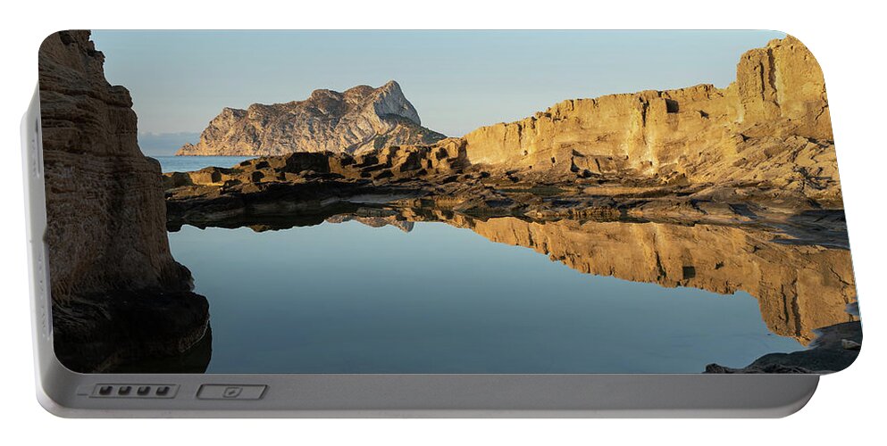 Mediterranean Portable Battery Charger featuring the photograph Reflection of rocks in the calm Mediterranean Sea at sunrise 3 by Adriana Mueller
