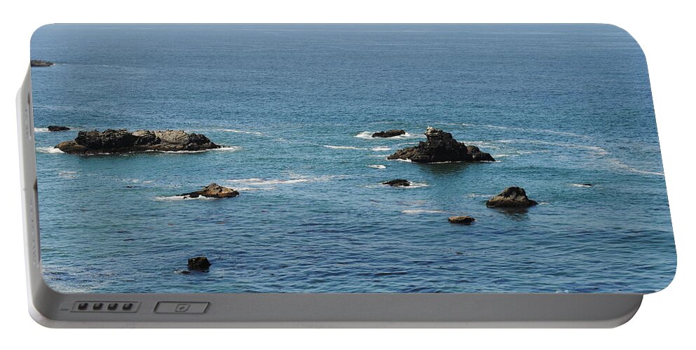 Landscape Portable Battery Charger featuring the photograph Rocks along the coast by Steven Wills