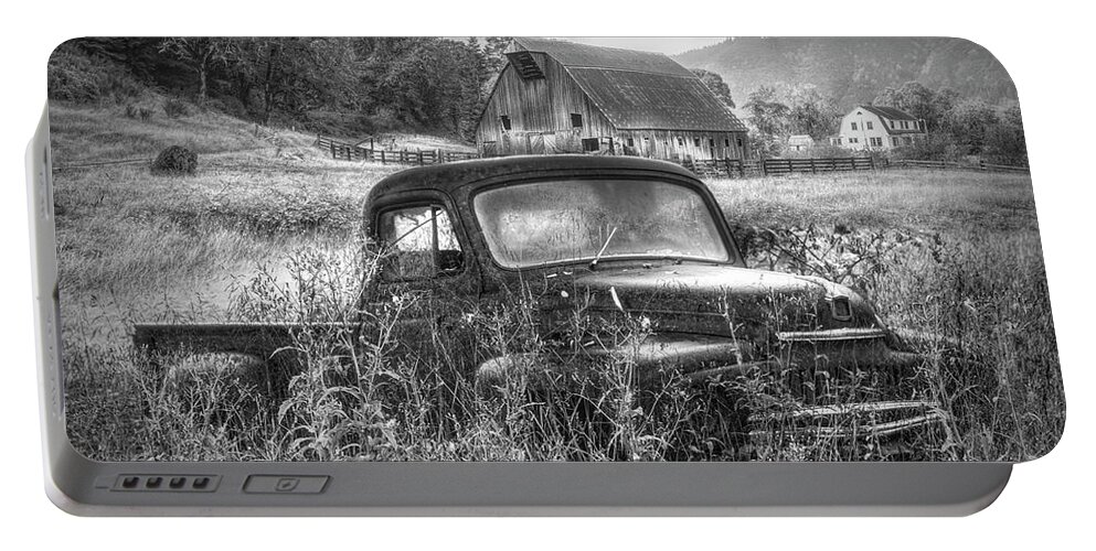 Barns Portable Battery Charger featuring the photograph Rusty Truck Deep in the Wildflowers in Black and White by Debra and Dave Vanderlaan