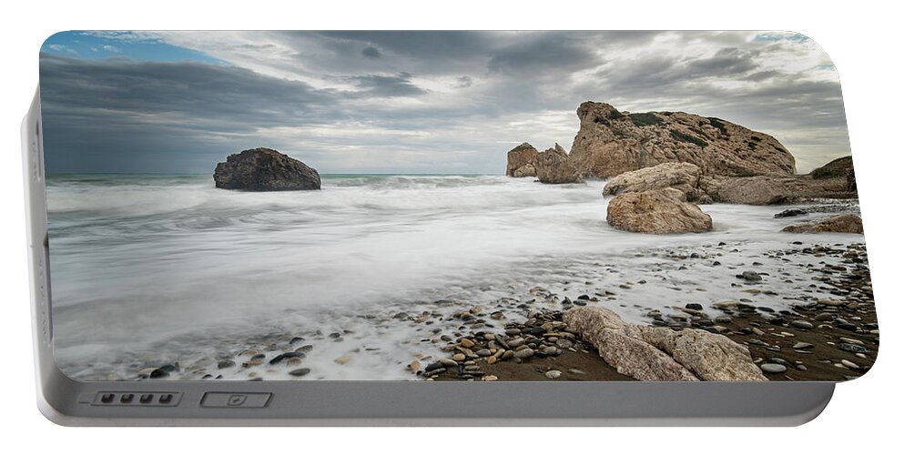 Seascape Portable Battery Charger featuring the photograph Seascape with windy waves splashing at the rocky coastal area. by Michalakis Ppalis