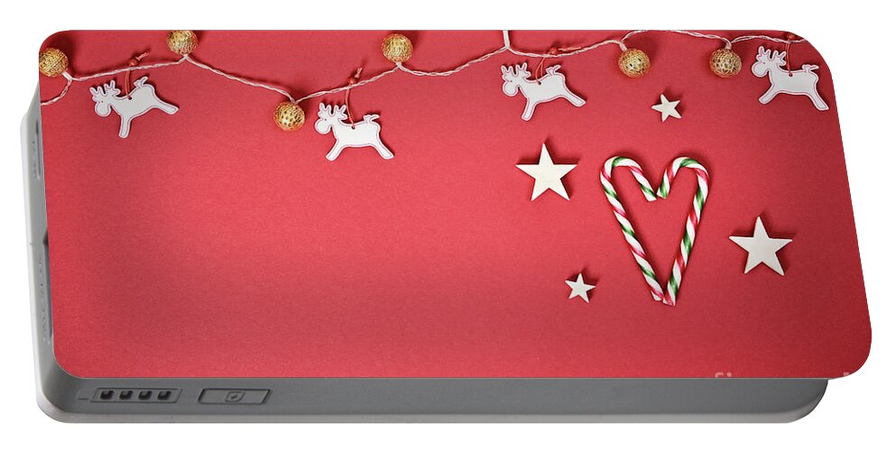 Seasonal Portable Battery Charger featuring the photograph Seasonal greeting card concept with Christmas lights and candy cane heart by Mendelex Photography