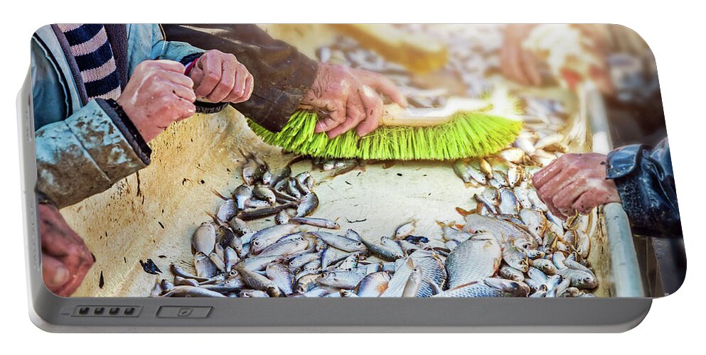 Sorting by hand fishes after catch of fish from pond Portable Battery  Charger by Gregory DUBUS - Pixels