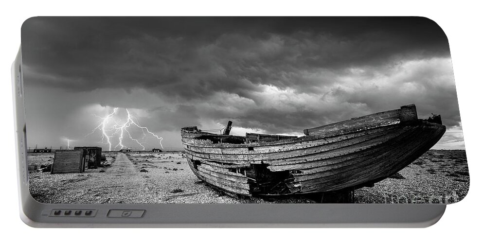 Stormy Sky Portable Battery Charger featuring the photograph Stormy Dungeness, Wrecked boat on a shingle beach with lightning by Neale And Judith Clark